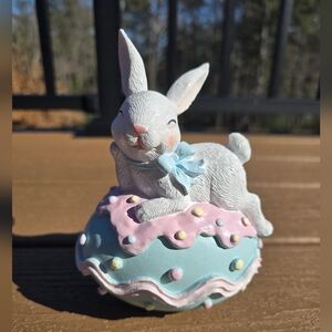 Spring Easter Bunny Relaxing on Top of a Frosted Egg